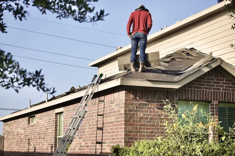 Professional roofer working on a residential roof in Beach